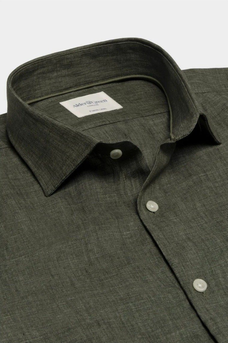 Green linen shirt collar detail flat lay photography