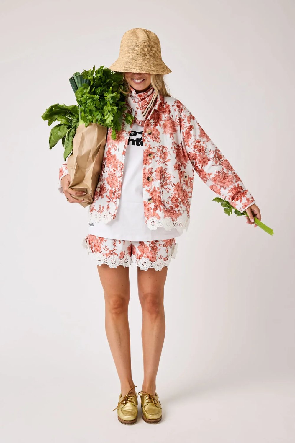 Lonestar Daughters floral jacket and lace-trim shorts, full length with a grocery bag